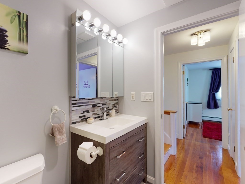 30 Kingston Road Waltham, MA 02451 - Photo 35 of 41 a bathroom with a sink vanity and mirror