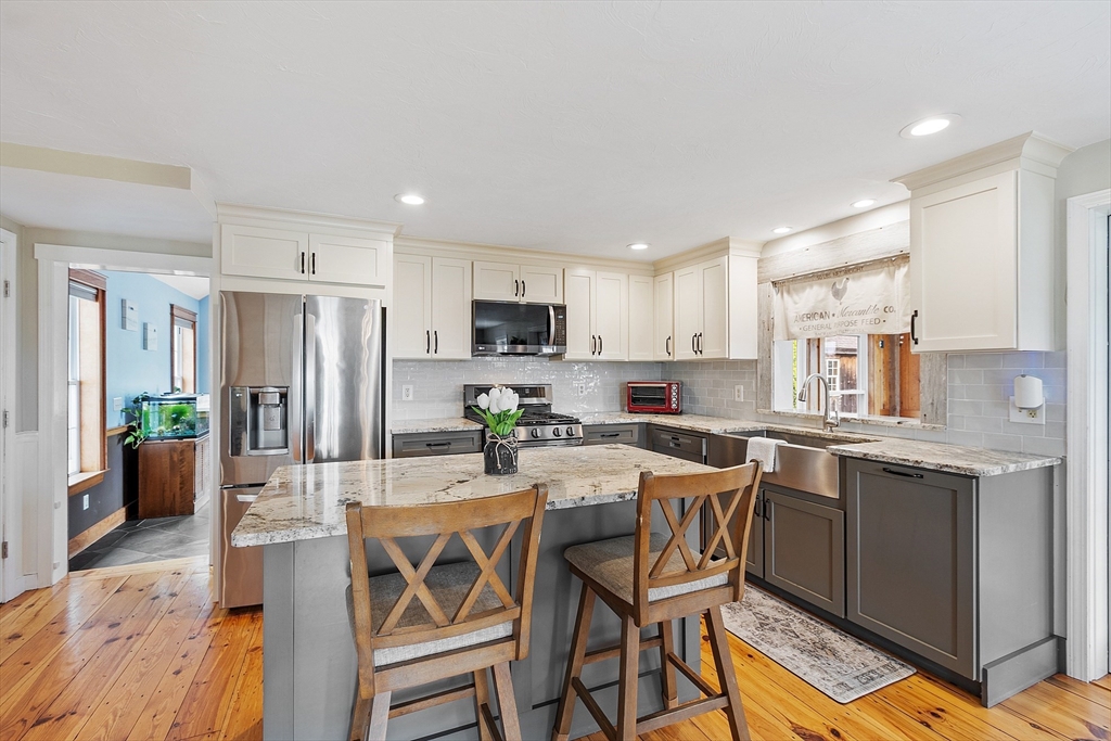 11 Syd Smith Road Westminster, MA 01473 - Photo 2 of 42 a kitchen with stainless steel appliances kitchen island granite countertop a dining table chairs and granite counter tops
