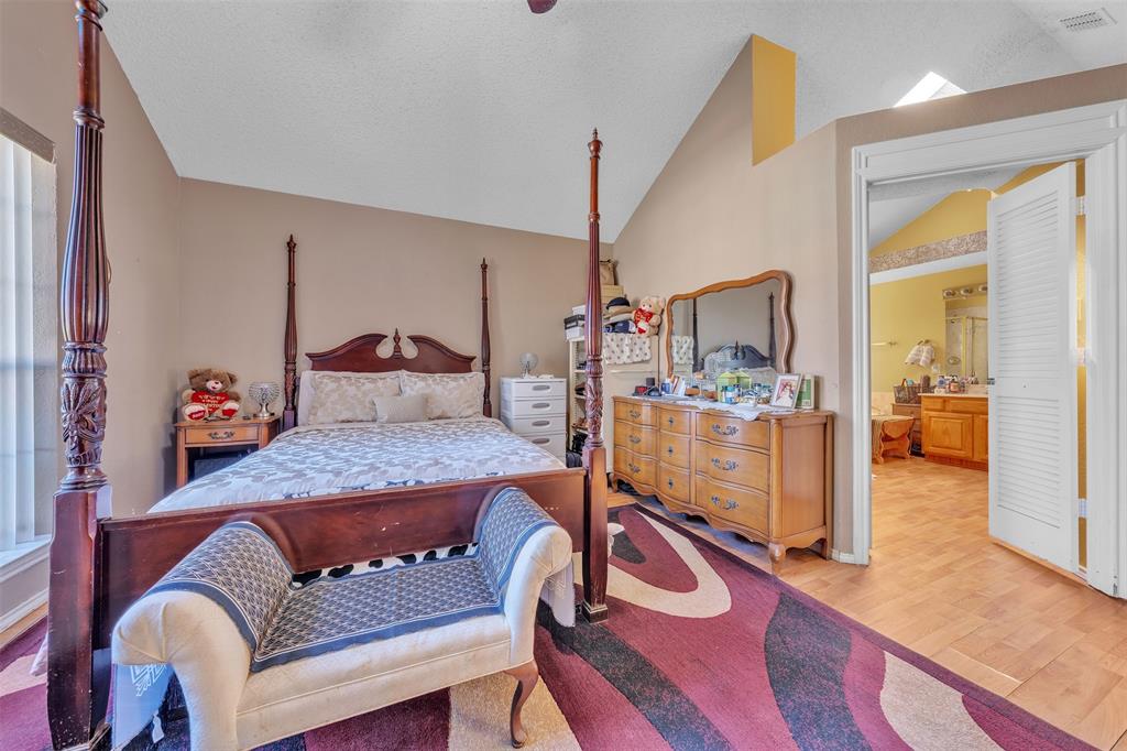 3405 Tulip Lane Rowlett, TX 75089 - Photo 11 of 36 a bedroom with furniture and a wooden floor