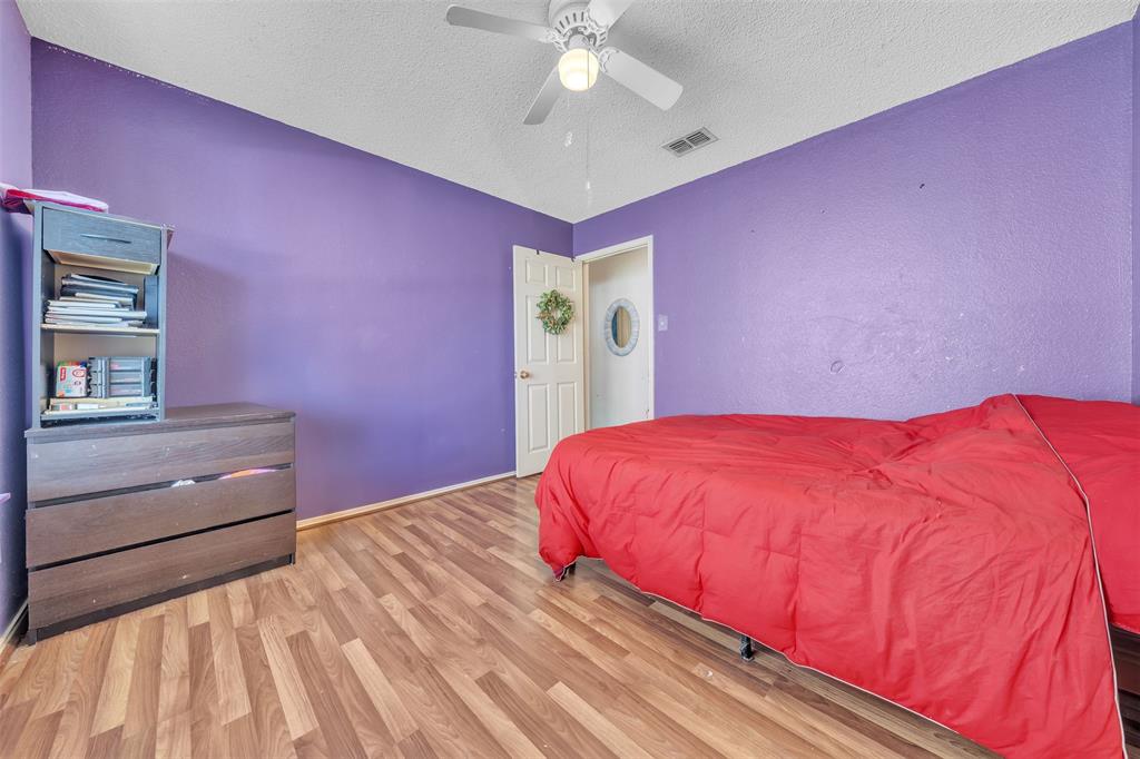 3405 Tulip Lane Rowlett, TX 75089 - Photo 17 of 36 a bedroom with a bed and a dresser