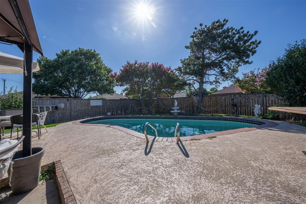 3405 Tulip Lane Rowlett, TX 75089 - Photo 27 of 36 a view of a backyard with wooden fence and a bench