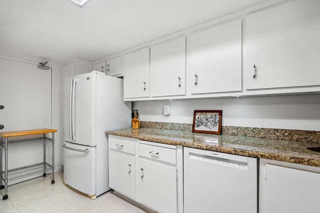 a kitchen with stainless steel appliances granite countertop a refrigerator sink and cabinets