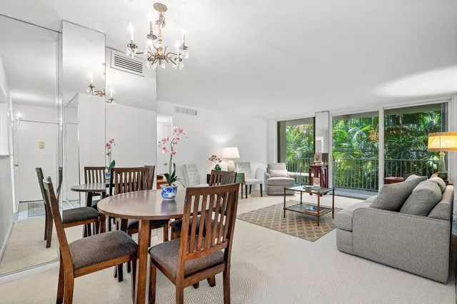 a dining room with furniture a chandelier and a rug