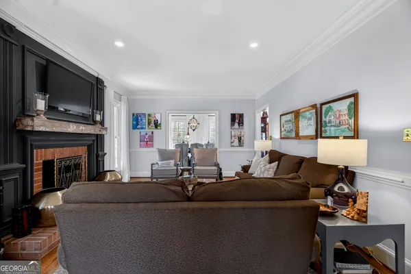 a living room with furniture a window and a flat screen tv