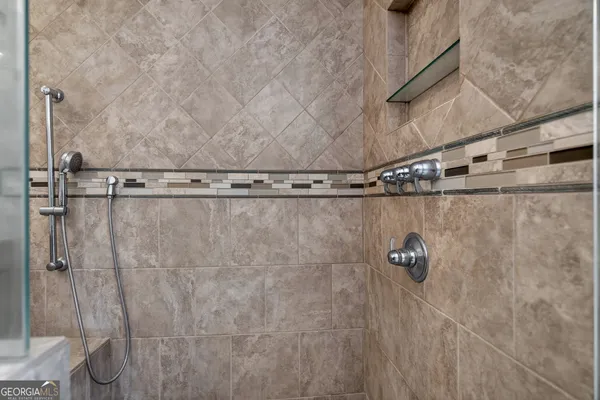 a bathroom with a sink a toilet a mirror and shower curtain