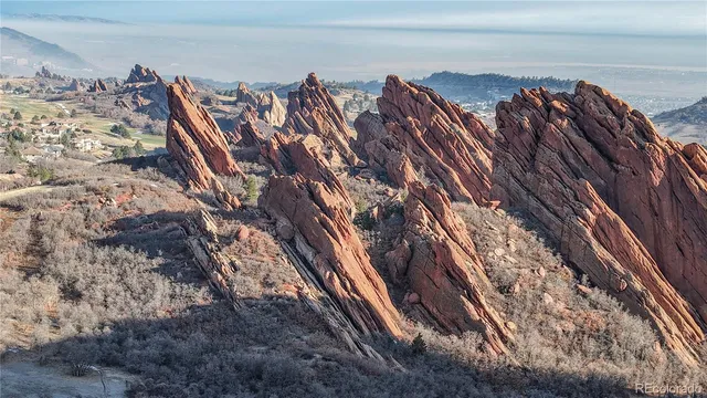 a aerial view of house with yard and mountain view in back