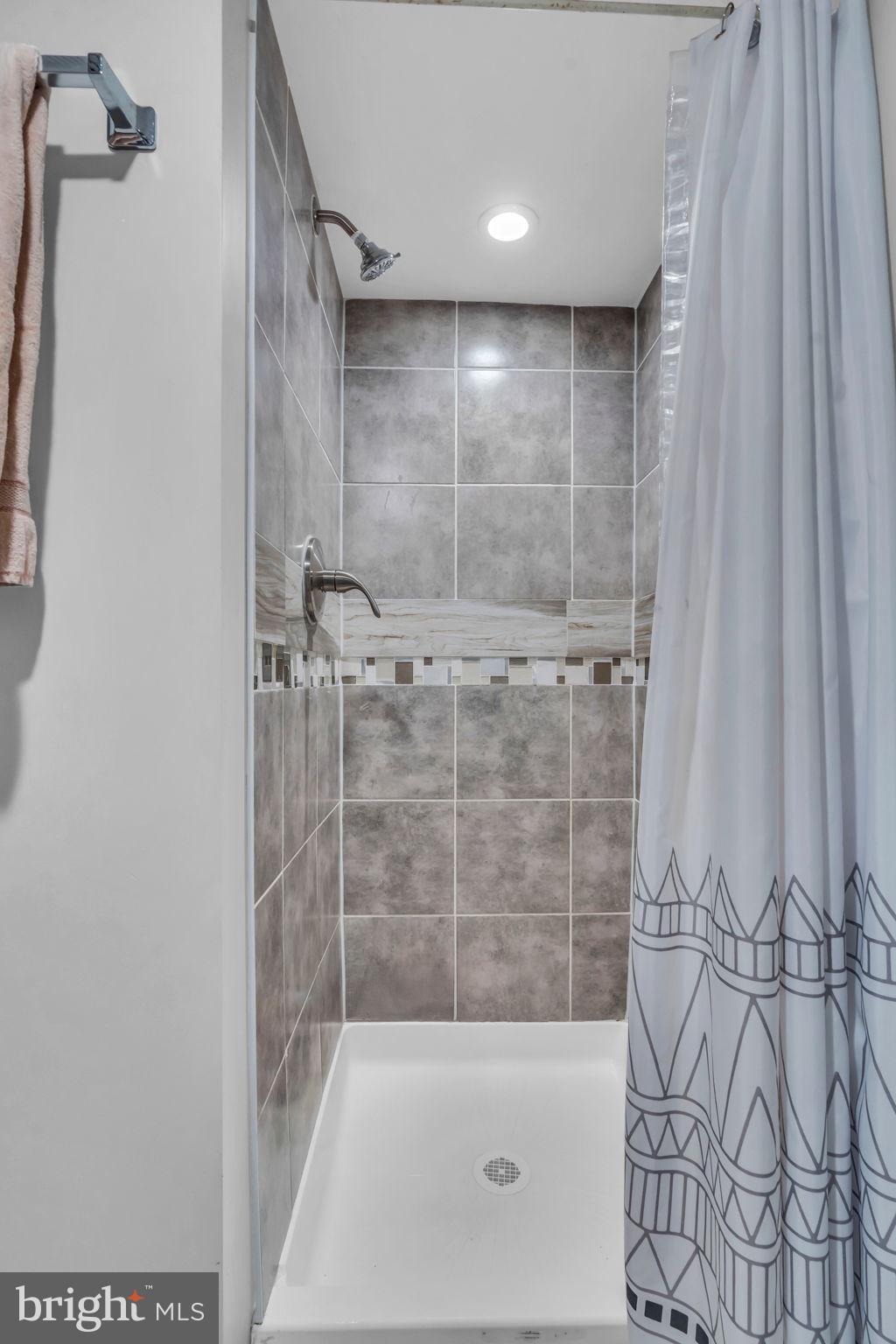 4908 1/2 Harford Road Baltimore, MD 21214 - Photo 17 of 20 a bathroom with a shower and a tub
