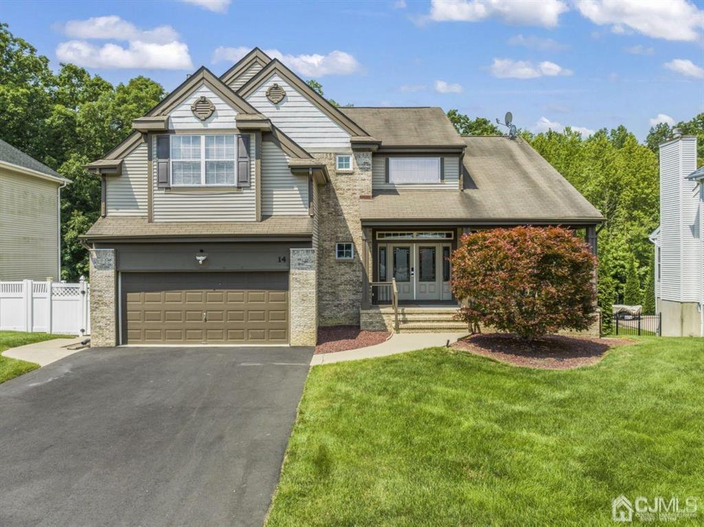 a front view of a house with a yard and garage