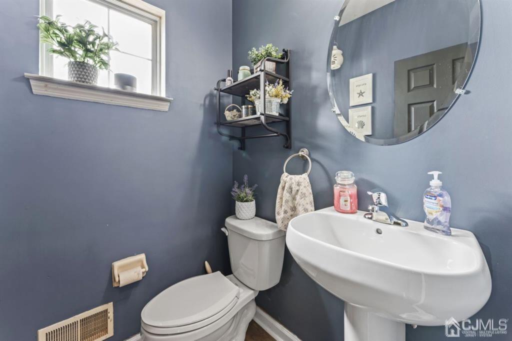 14 Reddington Drive Old Bridge, NJ 07747 - Photo 17 of 40 a bathroom with a toilet a sink and mirror