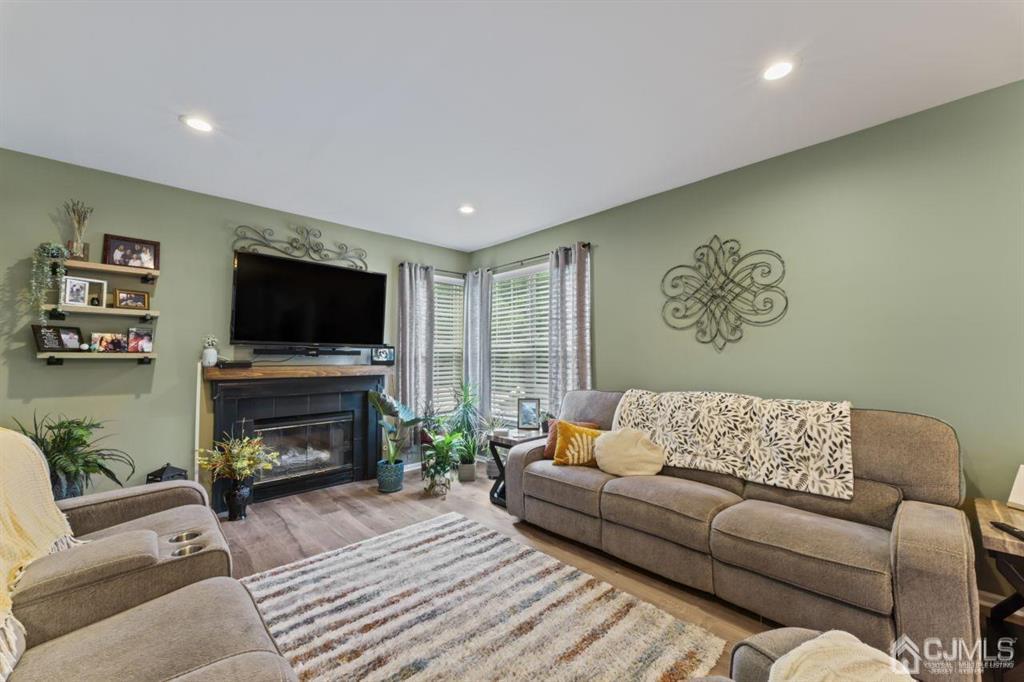 14 Reddington Drive Old Bridge, NJ 07747 - Photo 28 of 40 a living room with furniture a flat screen tv and a fireplace
