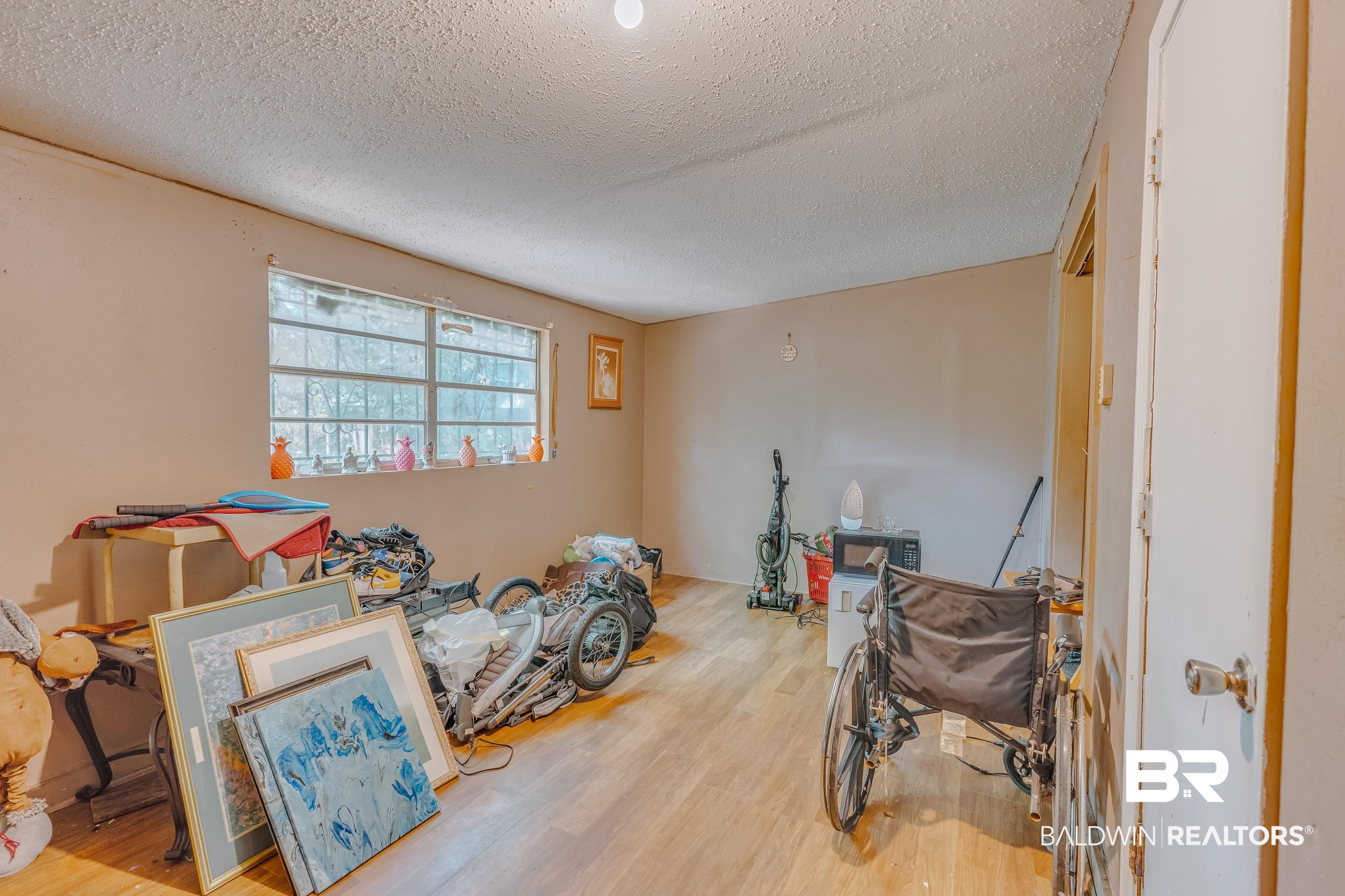 1156 Freeman Street Mobile, AL 36605 - Photo 10 of 22 Misc room with a textured ceiling and wood finished floors