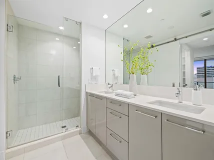 a bathroom with a shower sink and mirror