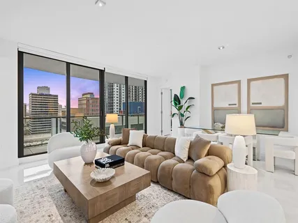 a living room with furniture and a large window