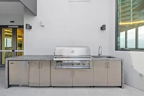 a roof deck with couches and potted plants