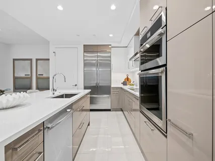 a kitchen with stainless steel appliances granite countertop a sink and dishwasher a stove top oven with wooden floor