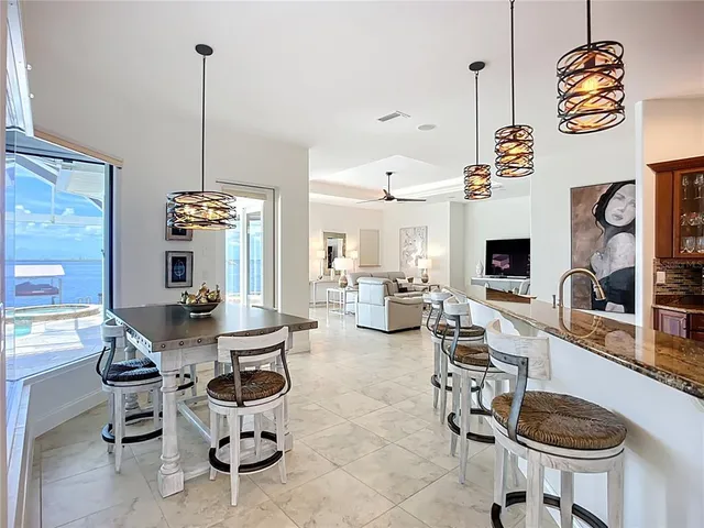 a kitchen with kitchen island granite countertop a stove and a sink with granite countertops