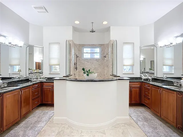 a view of a backyard with table and chairs under an umbrella