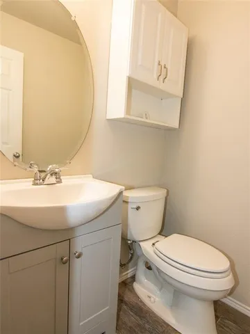 a bathroom with a sink a toilet and mirror