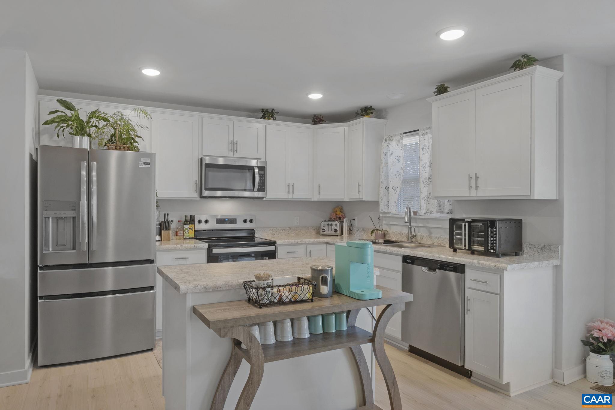 7440 Louisa Road Gordonsville, VA 22942 - Photo 12 of 40 a kitchen with a refrigerator a stove and a sink