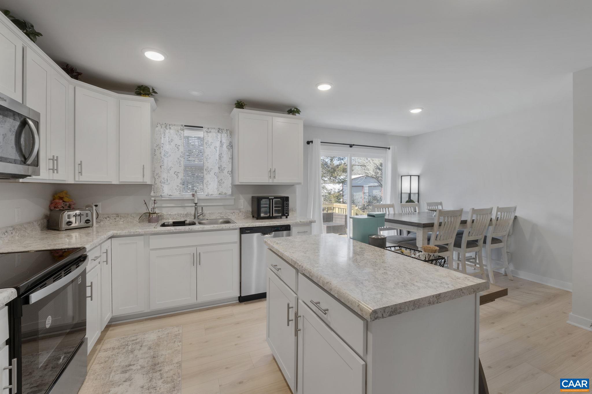 7440 Louisa Road Gordonsville, VA 22942 - Photo 14 of 40 a kitchen with a stove sink and cabinets