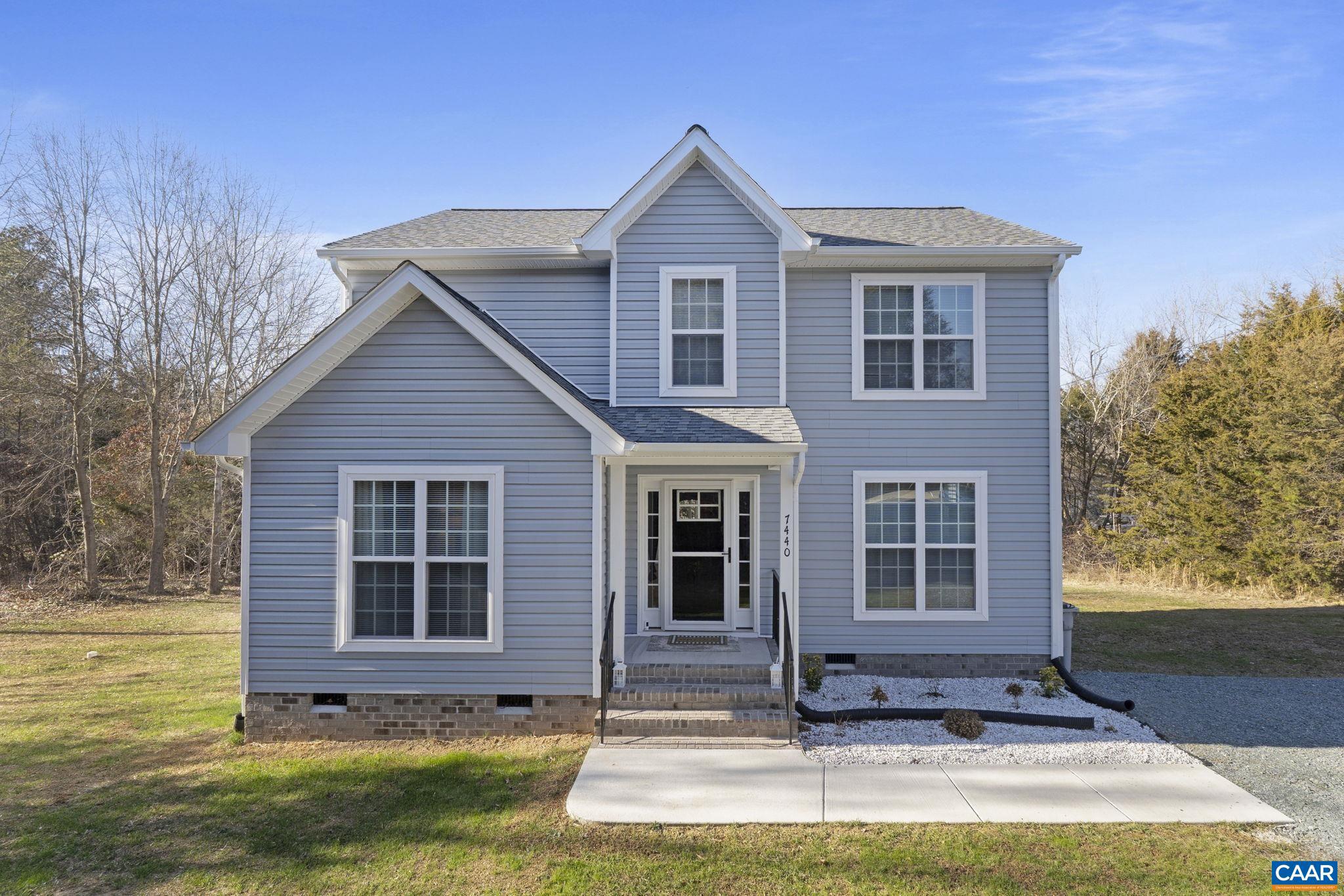 7440 Louisa Road Gordonsville, VA 22942 - Photo 2 of 40 a front view of a house with a yard