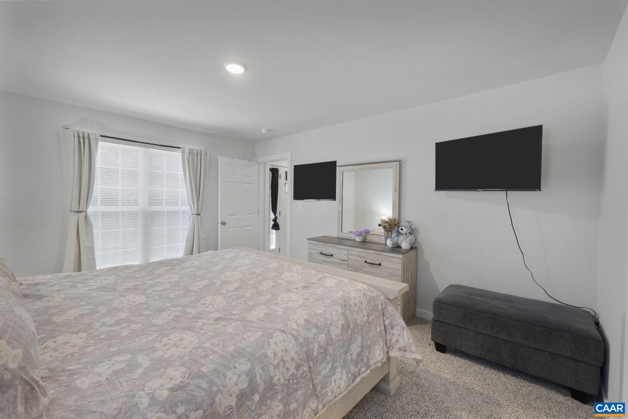 7440 Louisa Road Gordonsville, VA 22942 - Photo 22 of 40 a bedroom with a bed and a flat screen tv