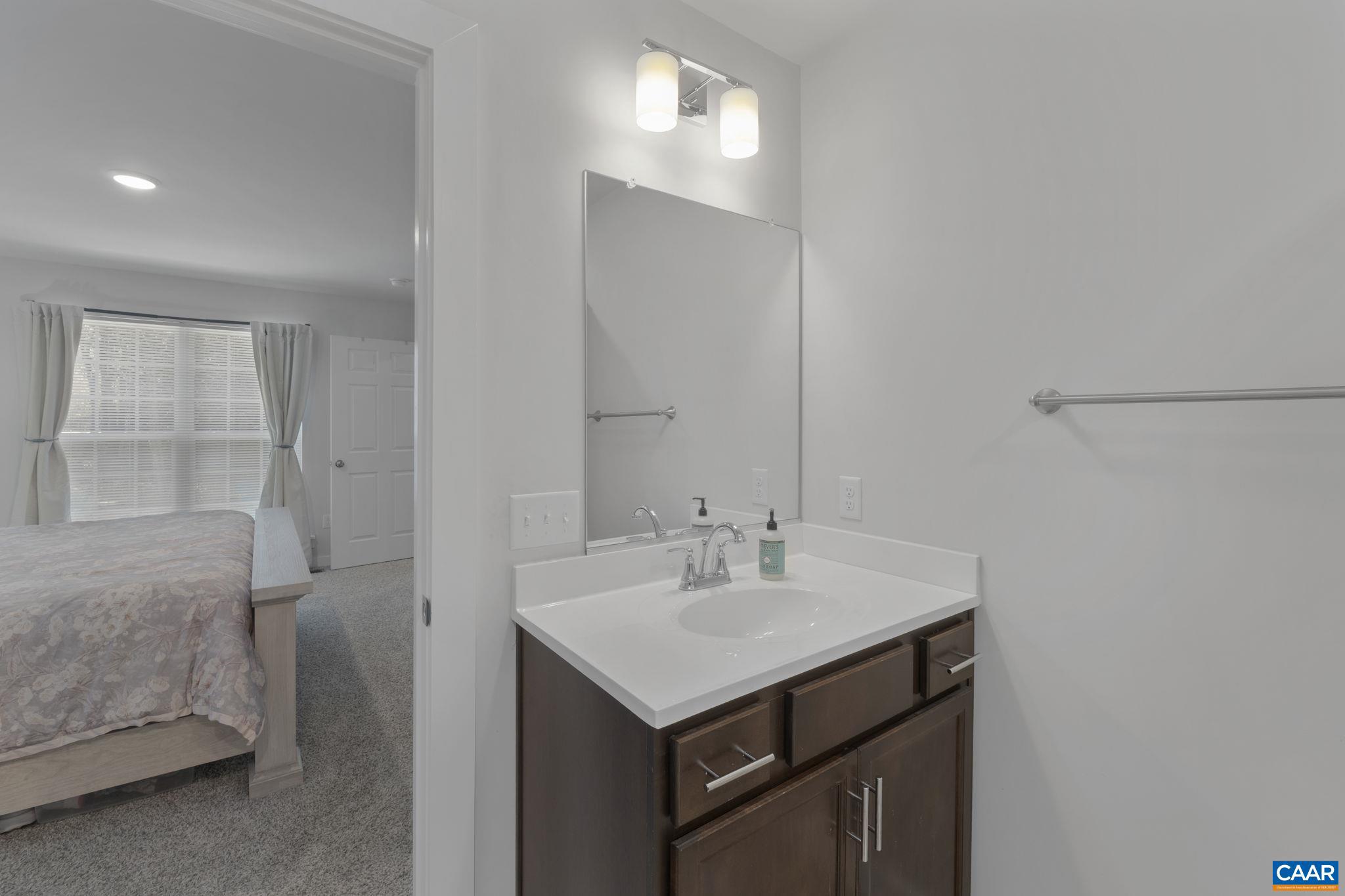 7440 Louisa Road Gordonsville, VA 22942 - Photo 24 of 40 a bathroom with a sink vanity and a mirror