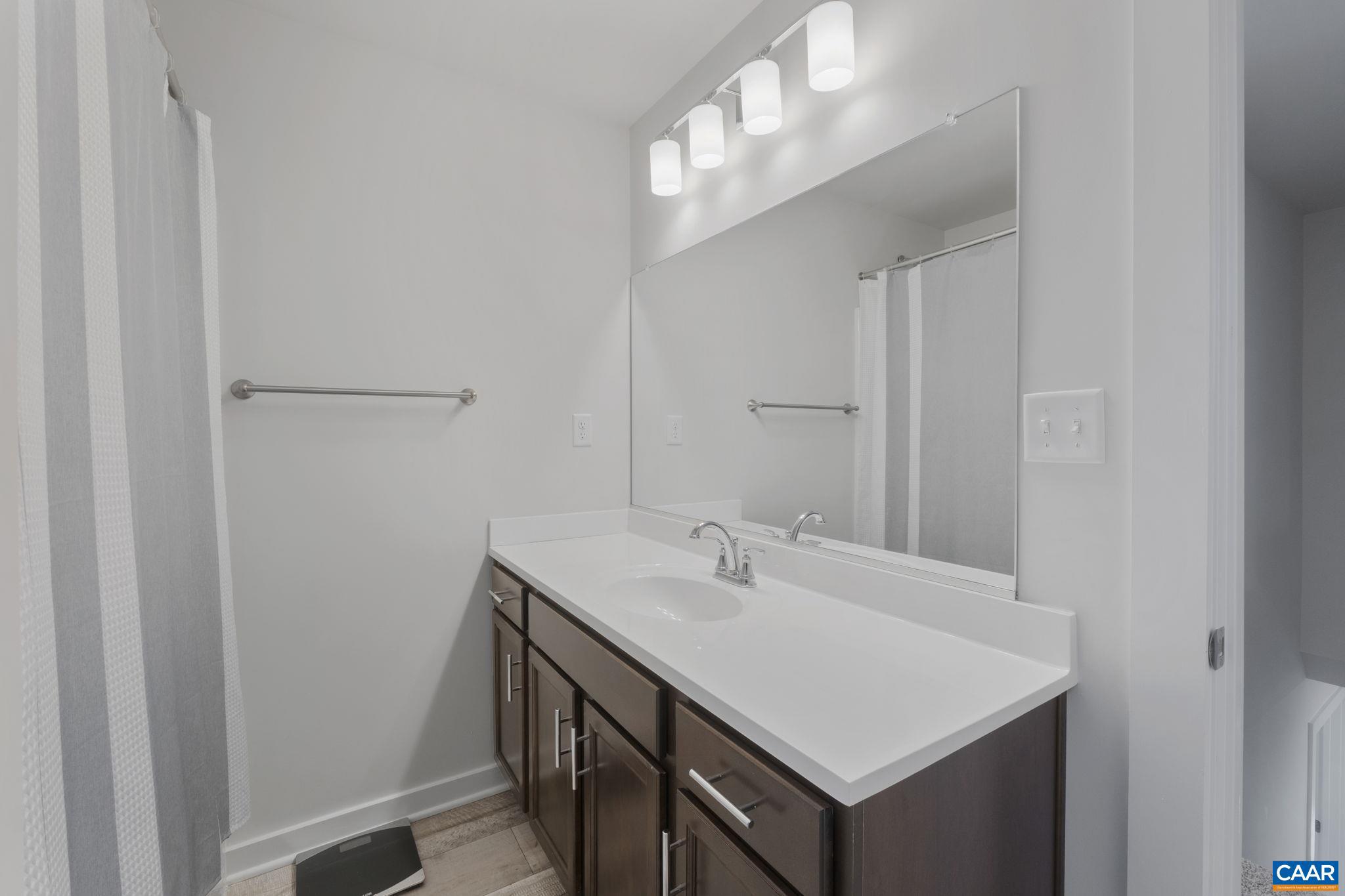 7440 Louisa Road Gordonsville, VA 22942 - Photo 29 of 40 a bathroom with a sink a vanity and a mirror