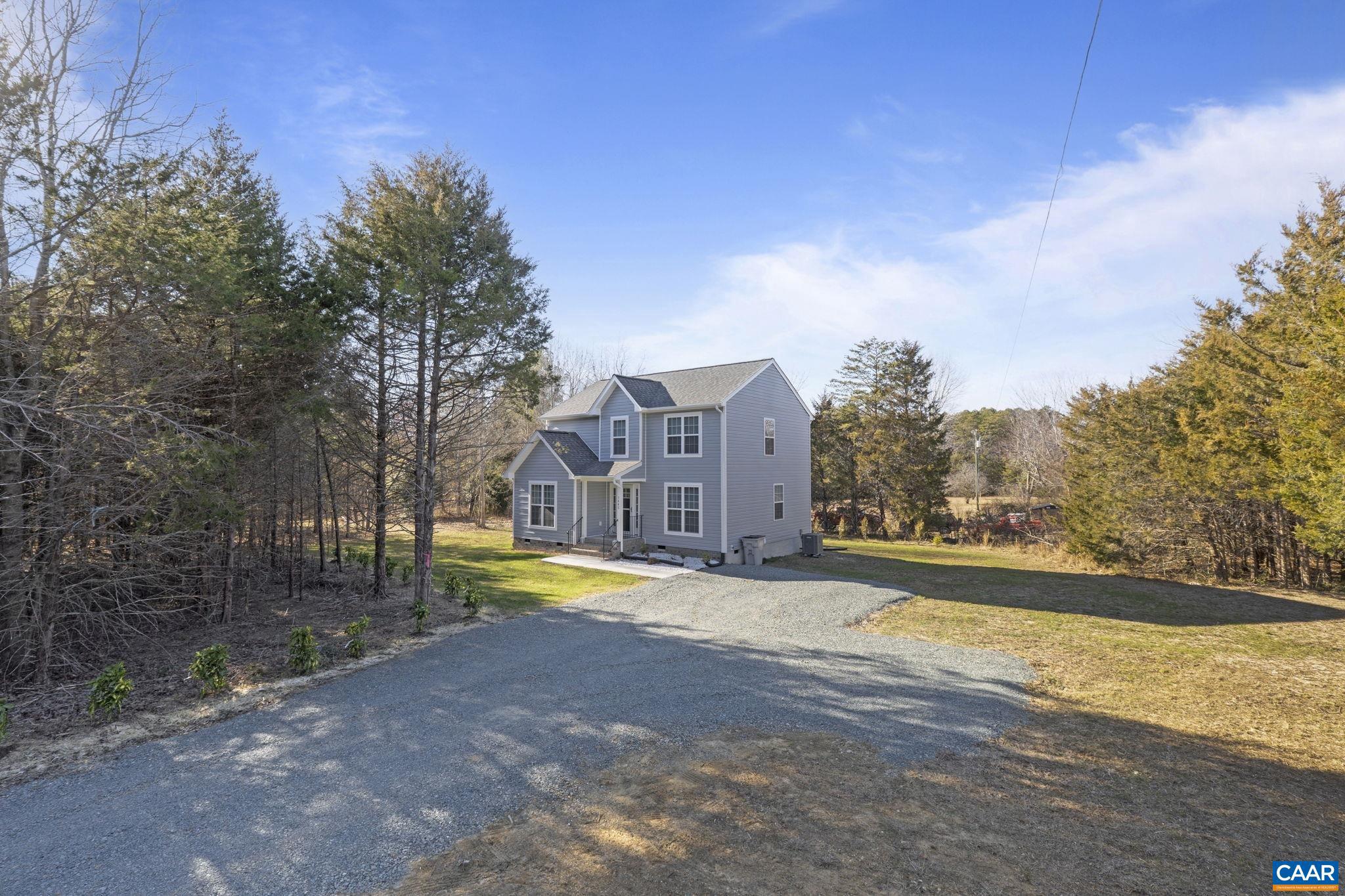 7440 Louisa Road Gordonsville, VA 22942 - Photo 33 of 40 a view of a house with a yard and a large tree