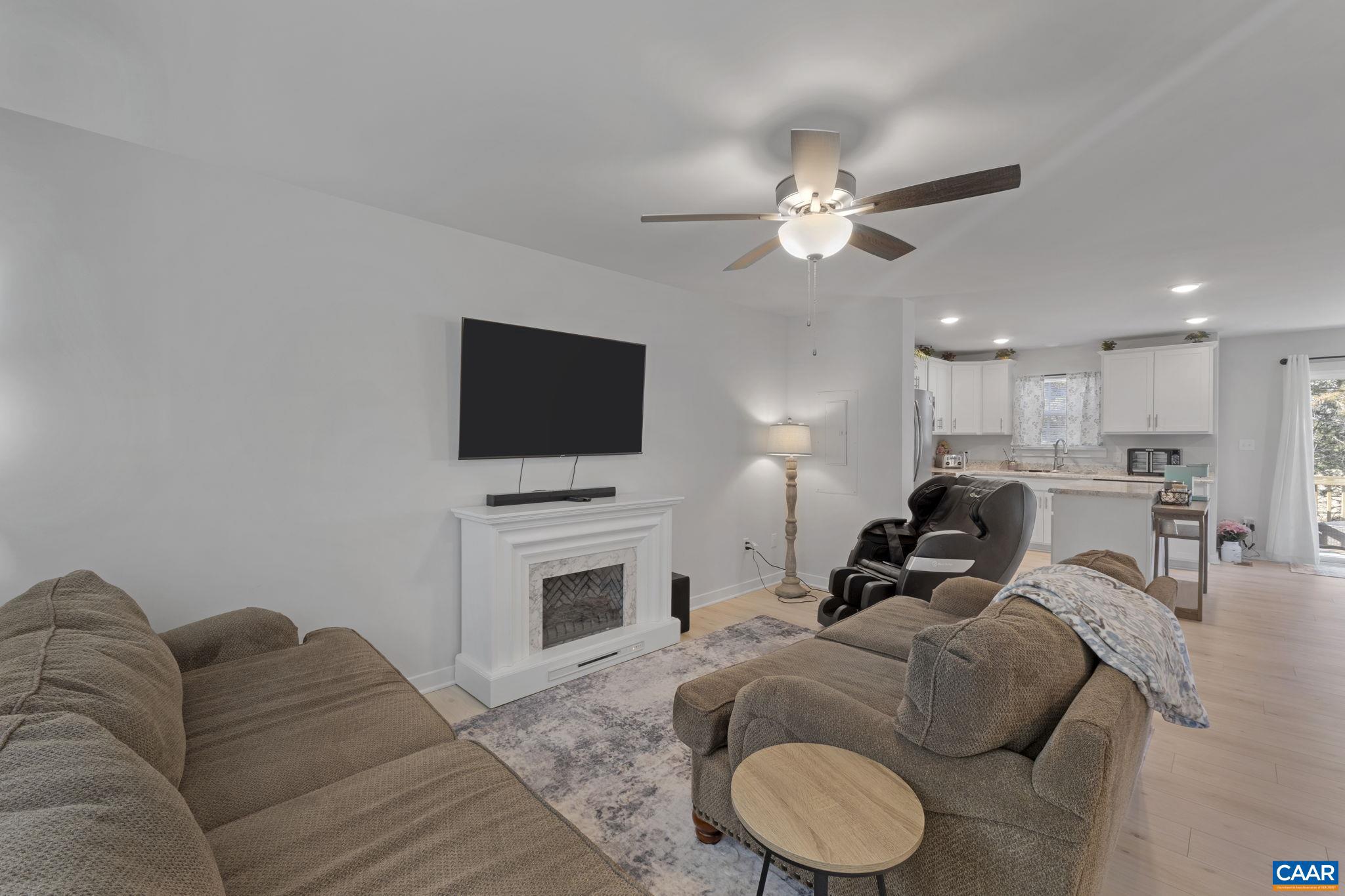 7440 Louisa Road Gordonsville, VA 22942 - Photo 9 of 40 a living room with furniture a flat screen tv and kitchen view