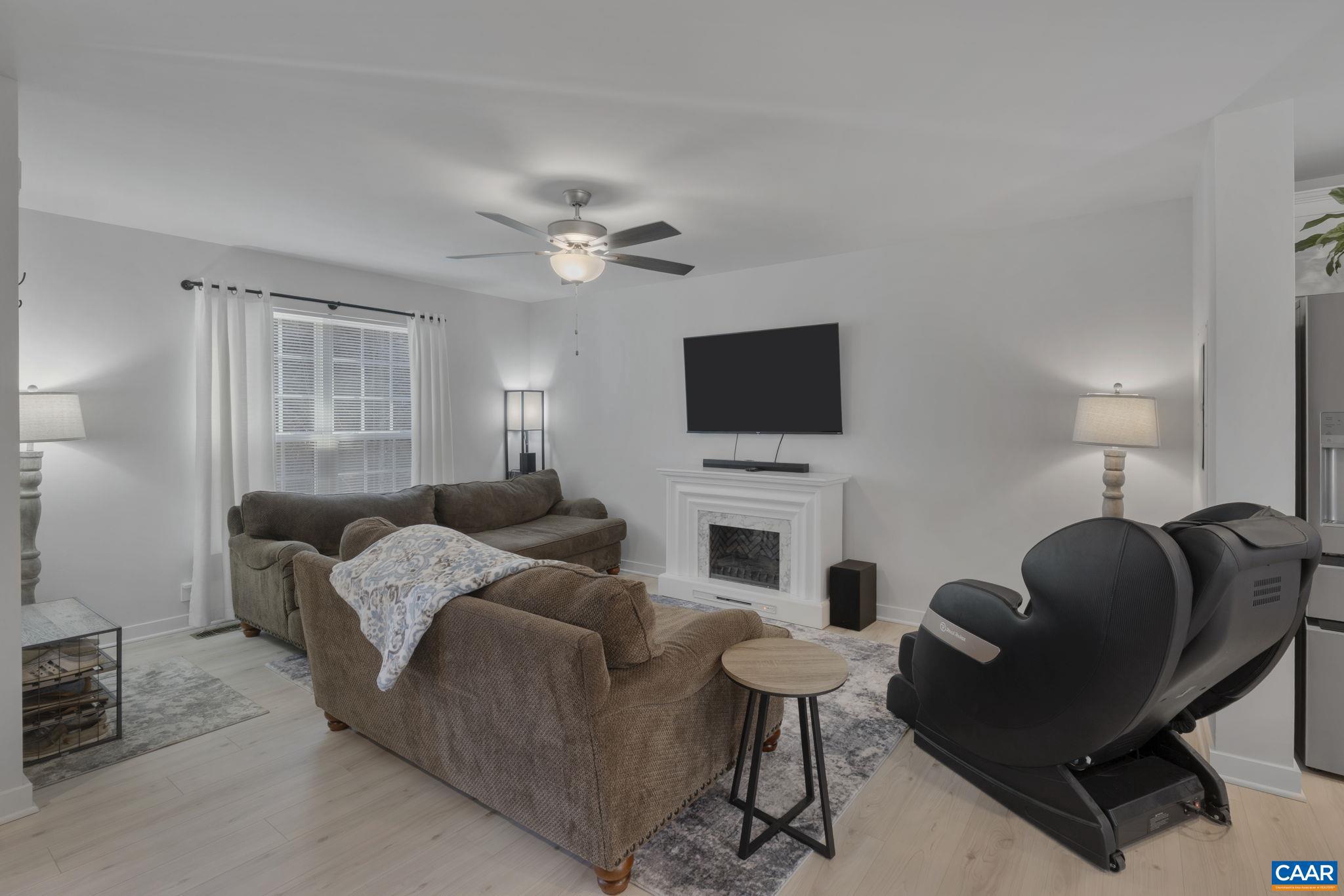 7440 Louisa Road Gordonsville, VA 22942 - Photo 10 of 40 a living room with furniture a fireplace and a flat screen tv