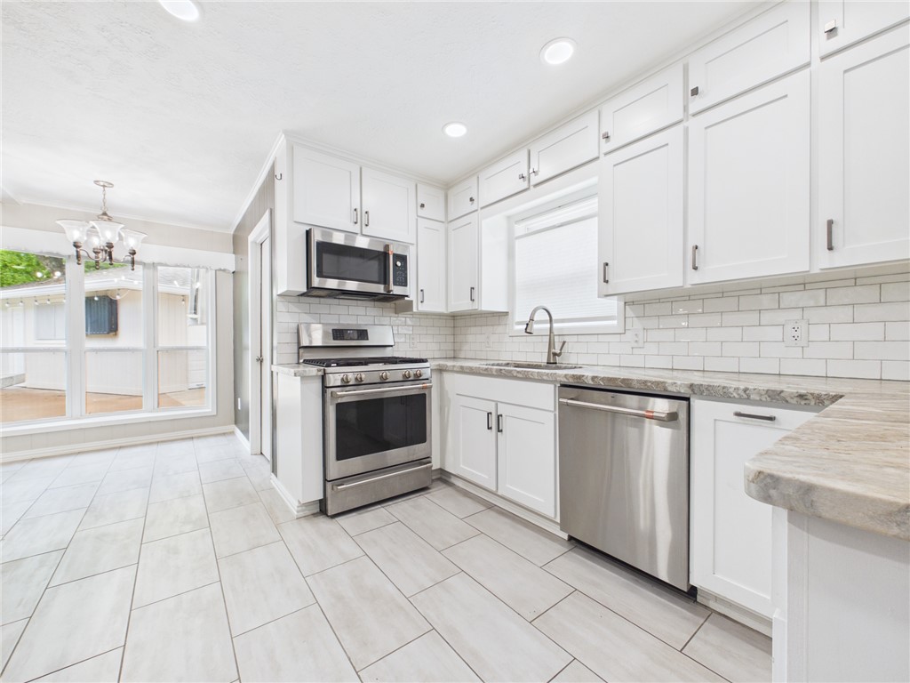 902 Briar Bend Court Bryan, TX 77802 - Photo 11 of 39 a kitchen with cabinets stainless steel appliances and a sink