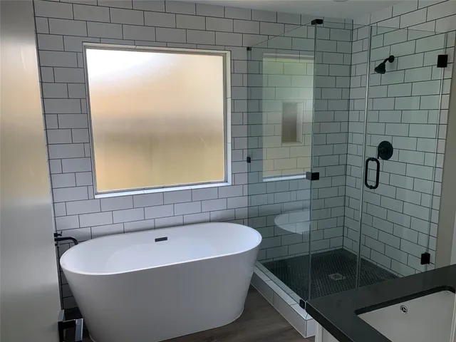 a bathroom with a bathtub and shower