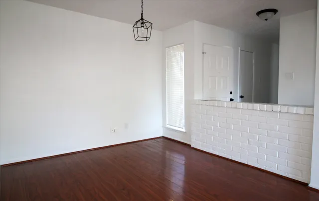 a view of a room with wooden floor