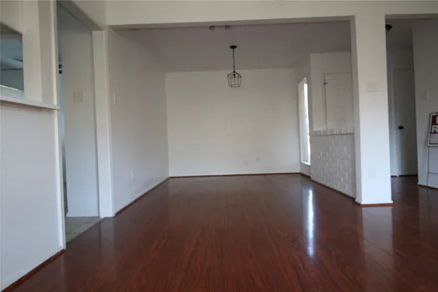 an empty room with wooden floor