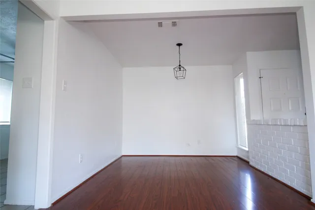 a view of a room with wooden floor and closet