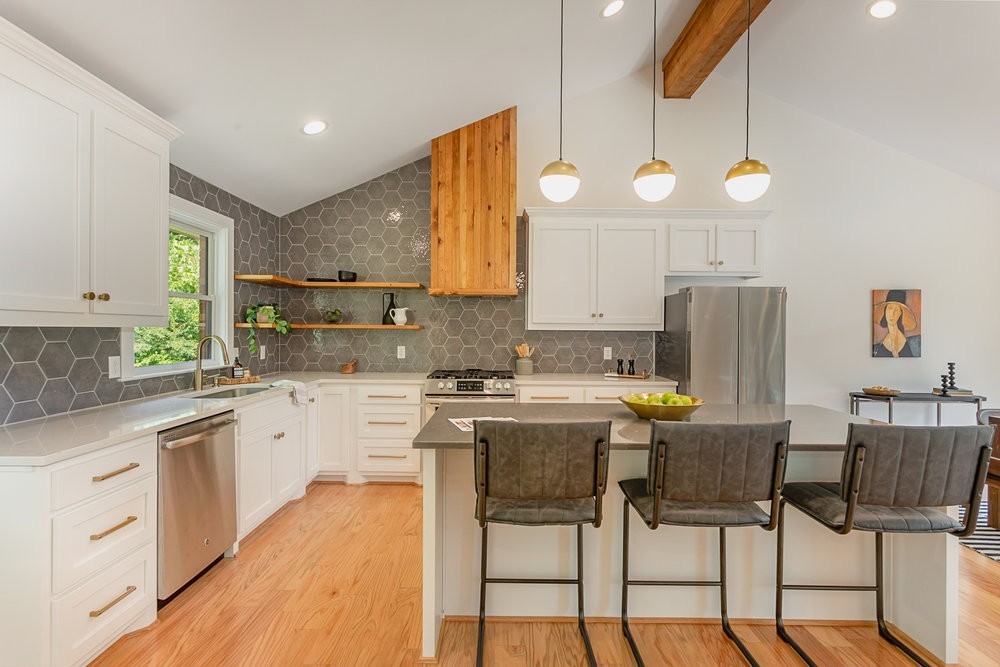5726 Knob Road Nashville, TN 37209 - Photo 8 of 29 The large living space also has a bar with wine fridge and open-shelving. The shelving and mantel are made from the original wood of the original roofing rafters! What a cool and thoughtful touch!