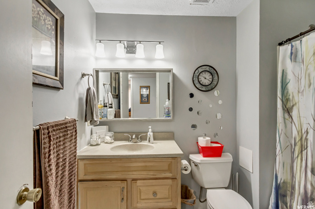 88 West 50 South, Unit B5 Centerville, UT 84014 - Photo 8 of 33 Bathroom with a shower with curtain, vanity, and a textured ceiling
