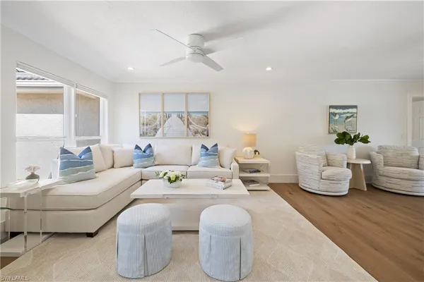 a living room with furniture dining table and wooden floor