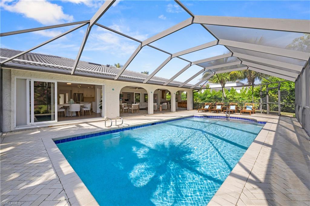4916 Crayton Road Naples, FL 34103 - Photo 20 of 34 a view of a house with a swimming pool