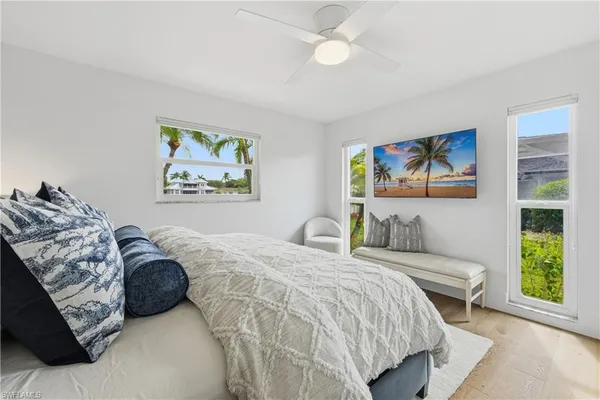 a large bed sitting in a bedroom and a table
