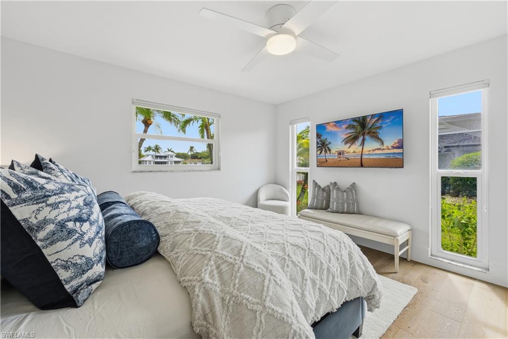 4916 Crayton Road Naples, FL 34103 - Photo 27 of 34 a bedroom with a bed a painting and a window