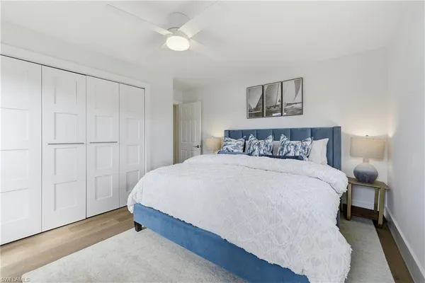 a spacious bedroom with a bed and a window