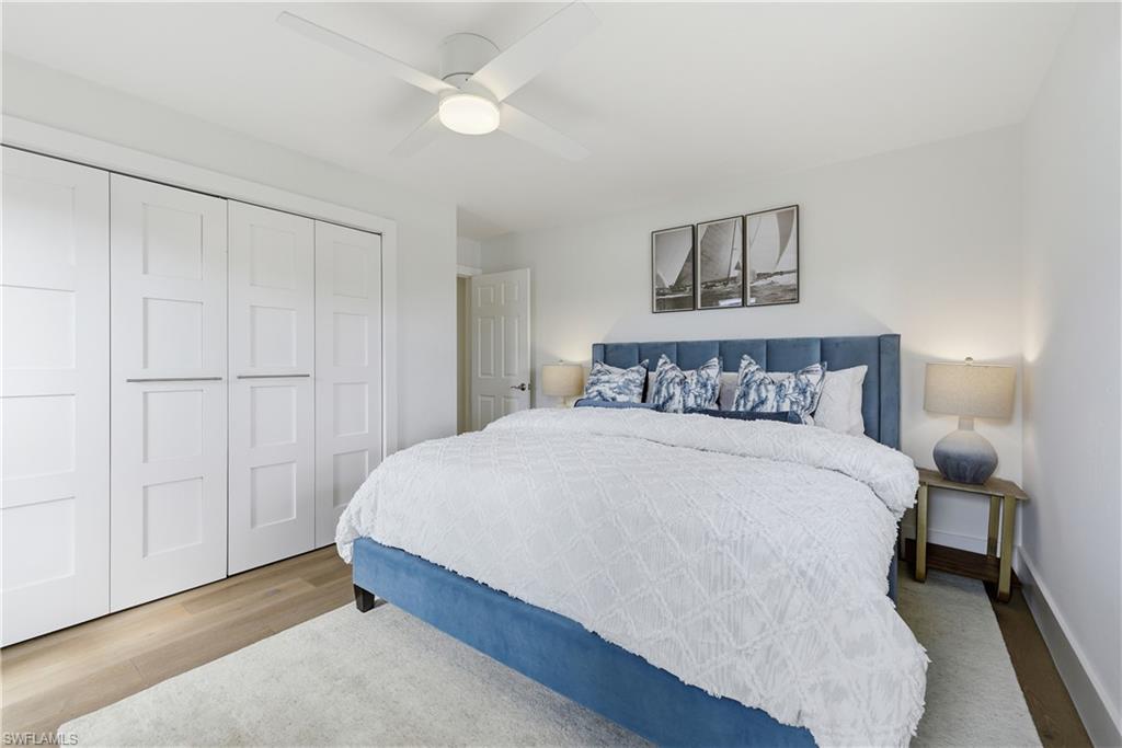 4916 Crayton Road Naples, FL 34103 - Photo 28 of 34 a large bed sitting in a bedroom and a table