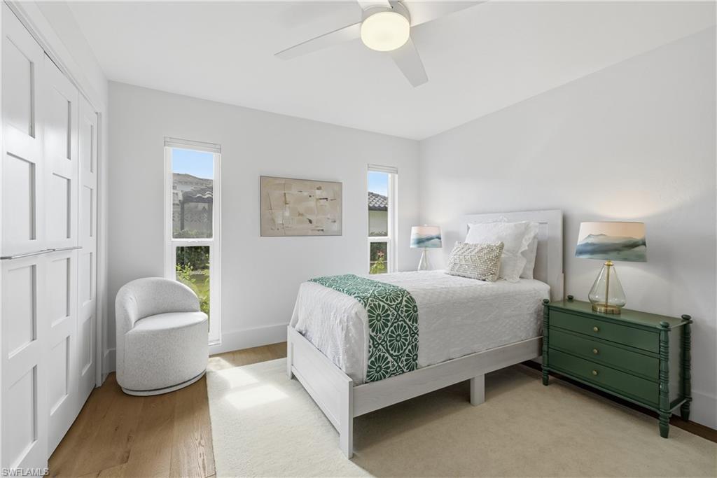 4916 Crayton Road Naples, FL 34103 - Photo 29 of 34 a spacious bedroom with a bed and a window
