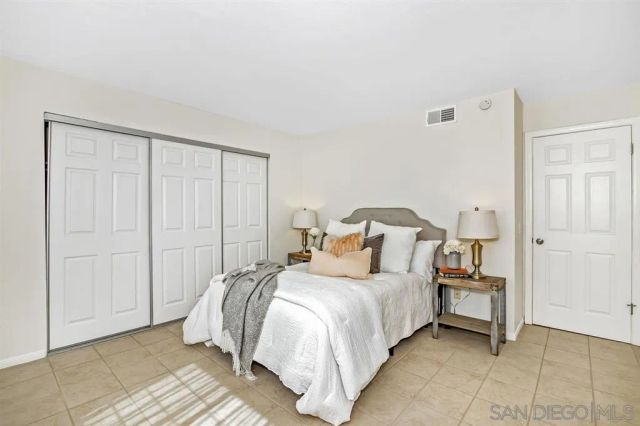 a bedroom with a bed and a closet