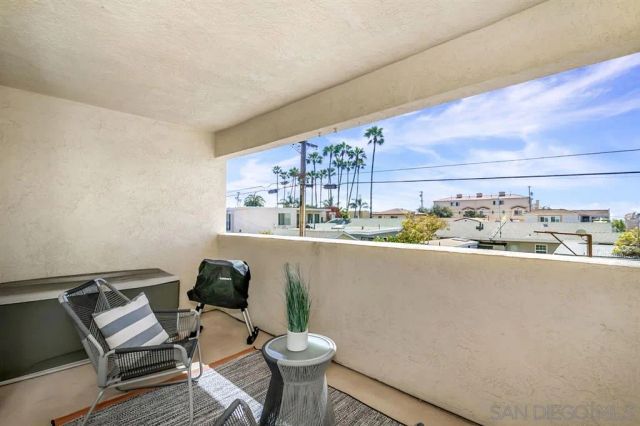 a view of a chairs and table in a balcony