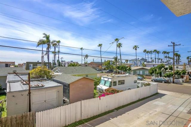 a view of a balcony furniture and kitchen view