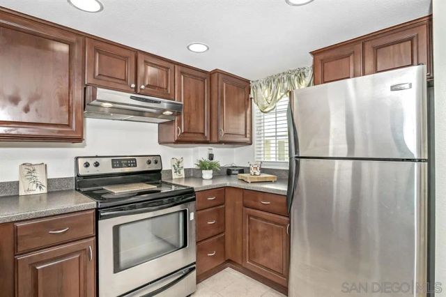 a kitchen with granite countertop a refrigerator stove and microwave