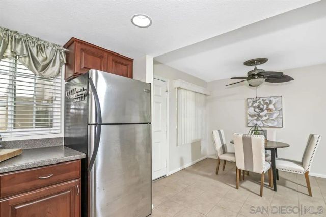 a refrigerator and a chair in a kitchen